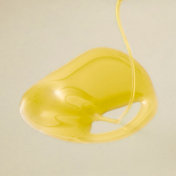 extra virgin olive oil drizzled on to white surface
