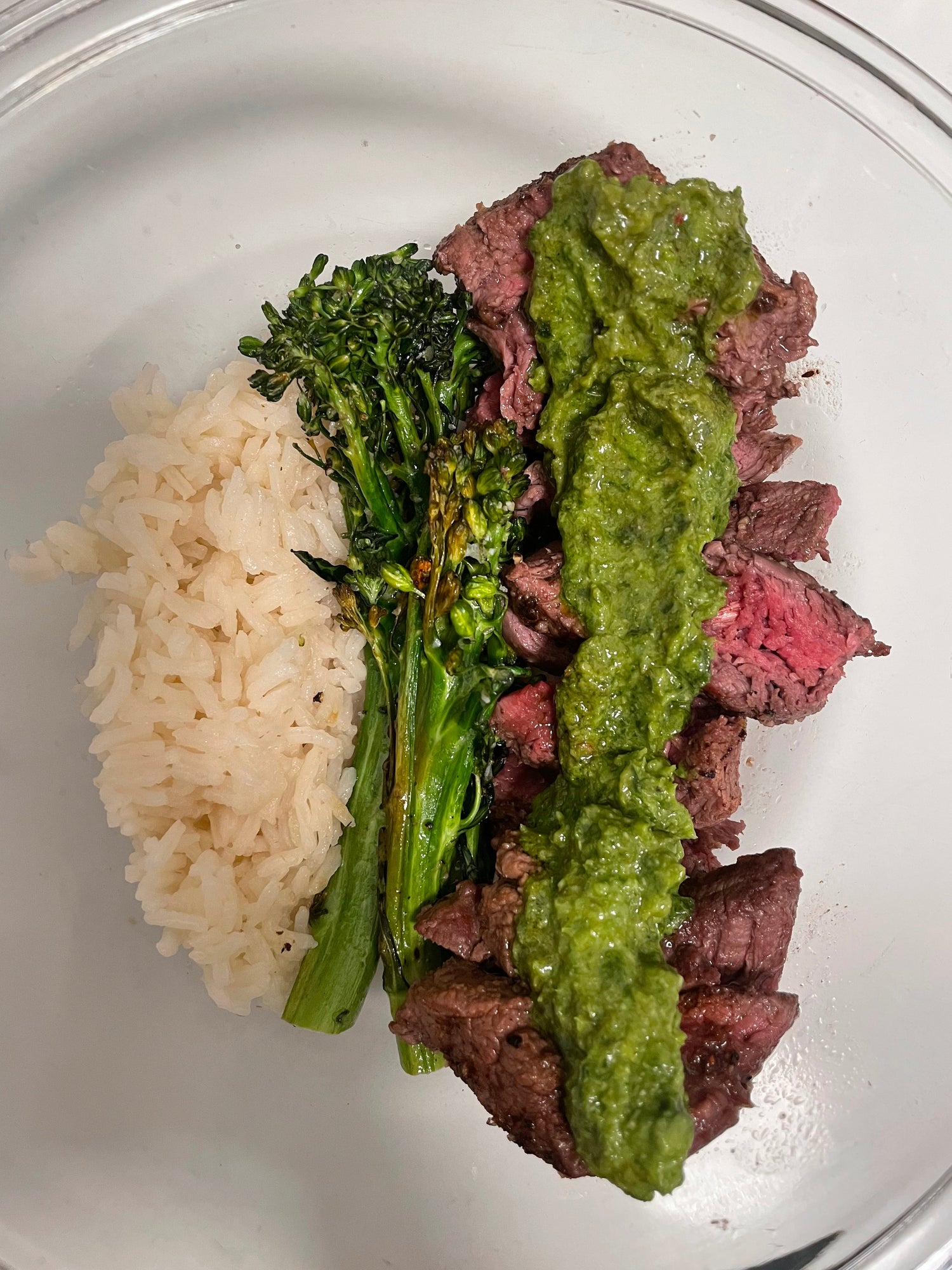 Bone broth white rice, oven roasted broccoli, and medium rare filet mignon drizzled with Besto on top. 