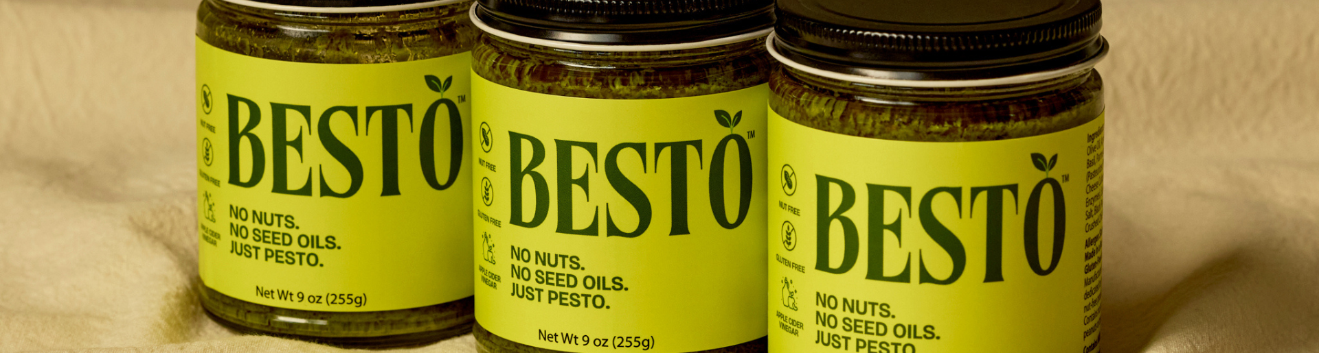 three jars of besto nut free pesto lined up on beige background