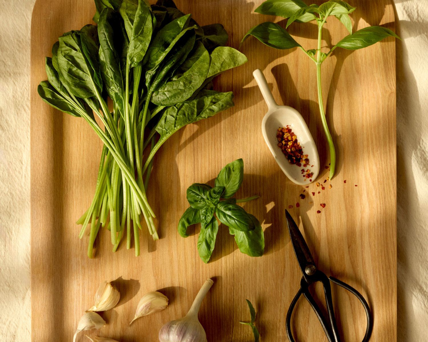 spinach basil red crushed chili flakes and garlic to make besto nut free pesto