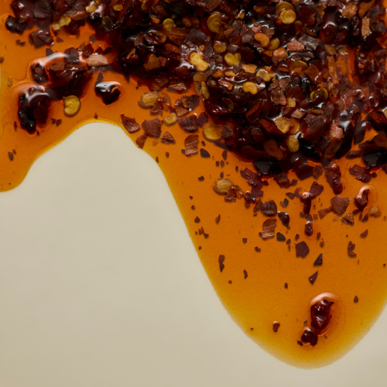 red crushed chili flakes blended with extra virgin olive oil dripping 